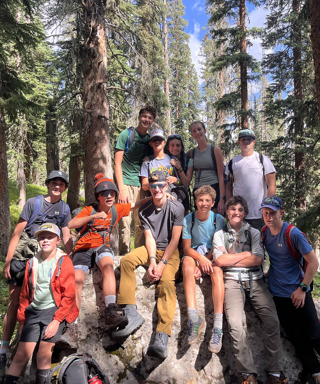 Summit & Service students pose together on a boulder