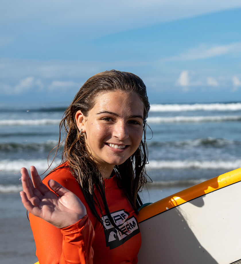 A Surf Term student waving at the camera