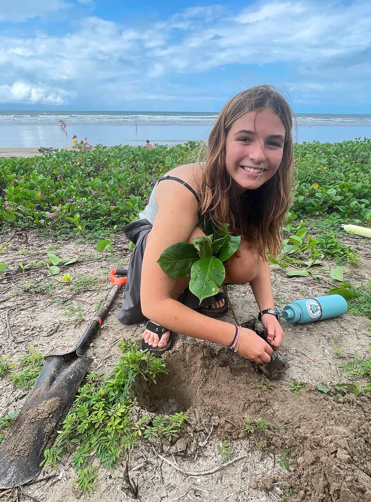 Surf & Service student digs in the sand