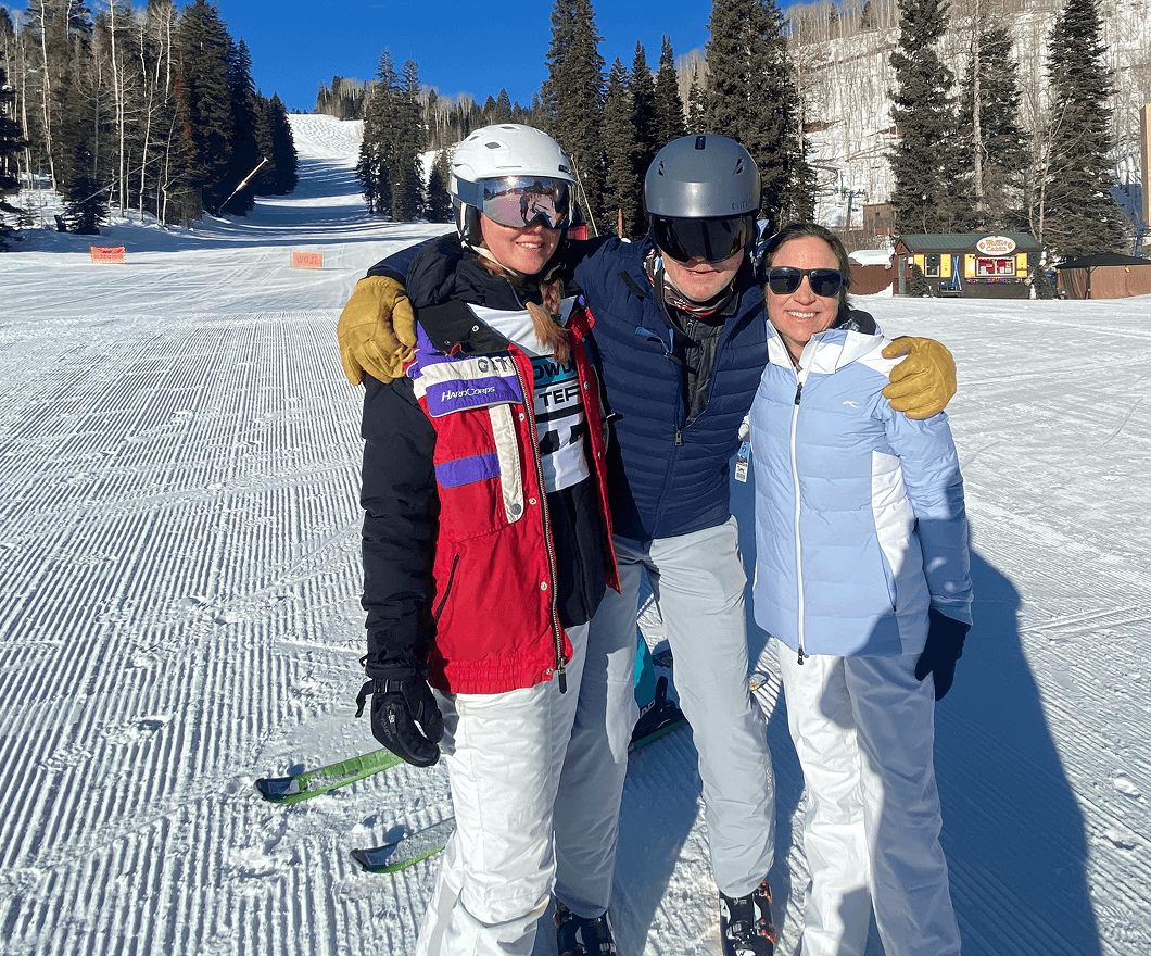 Powder Term attendees pose at the bottom of a ski slope