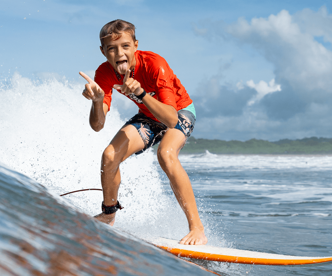 A Discover Term student rides a wave in Costa Rica