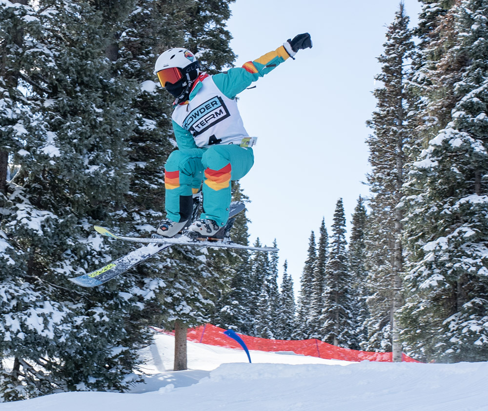 Teen catching air on skis during Powder Term