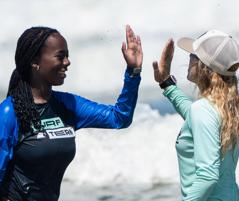 Teen celebrating after catching a wave while surfing