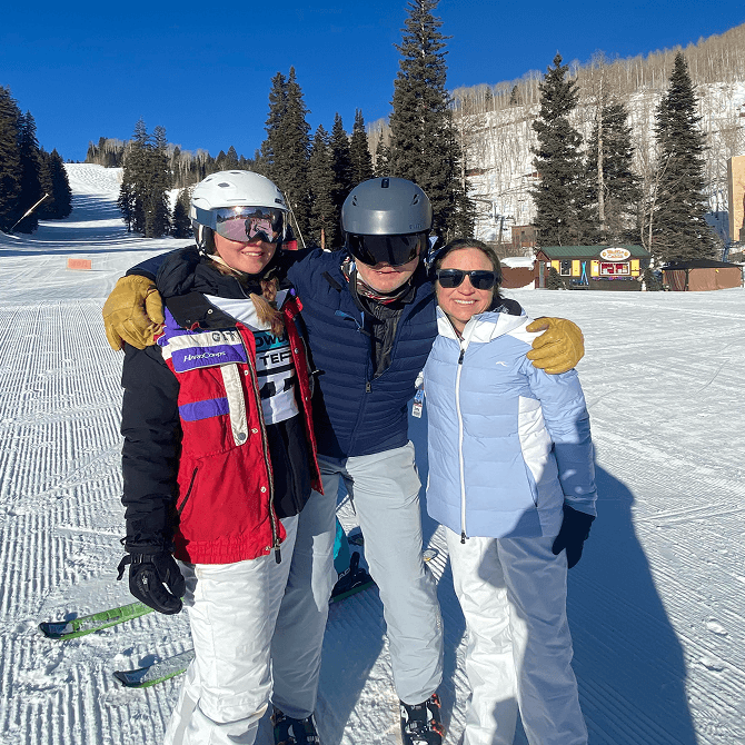 Powder Term attendees pose at the bottom of a ski slope